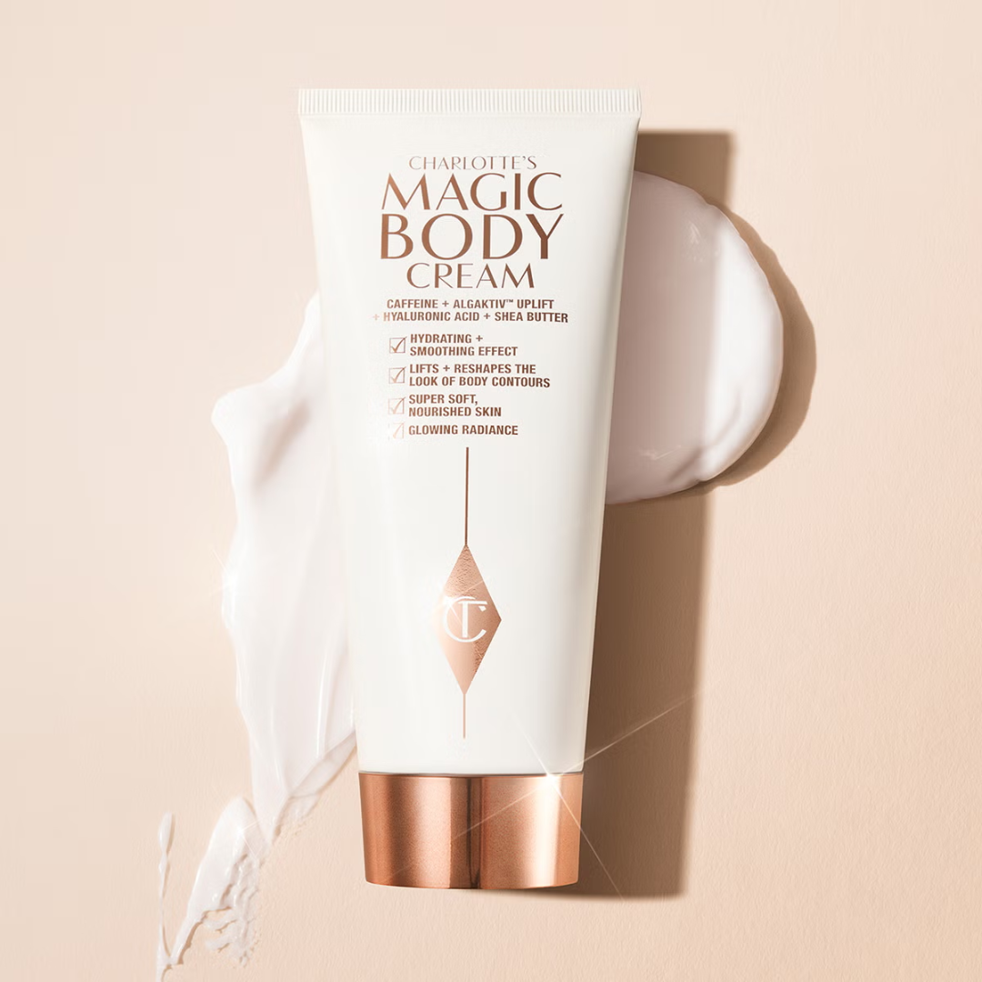 White tube of Charlotte's Magic Body Cream with gold text on a white background